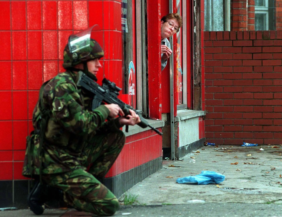  A British soldier takes cover in North Belfast