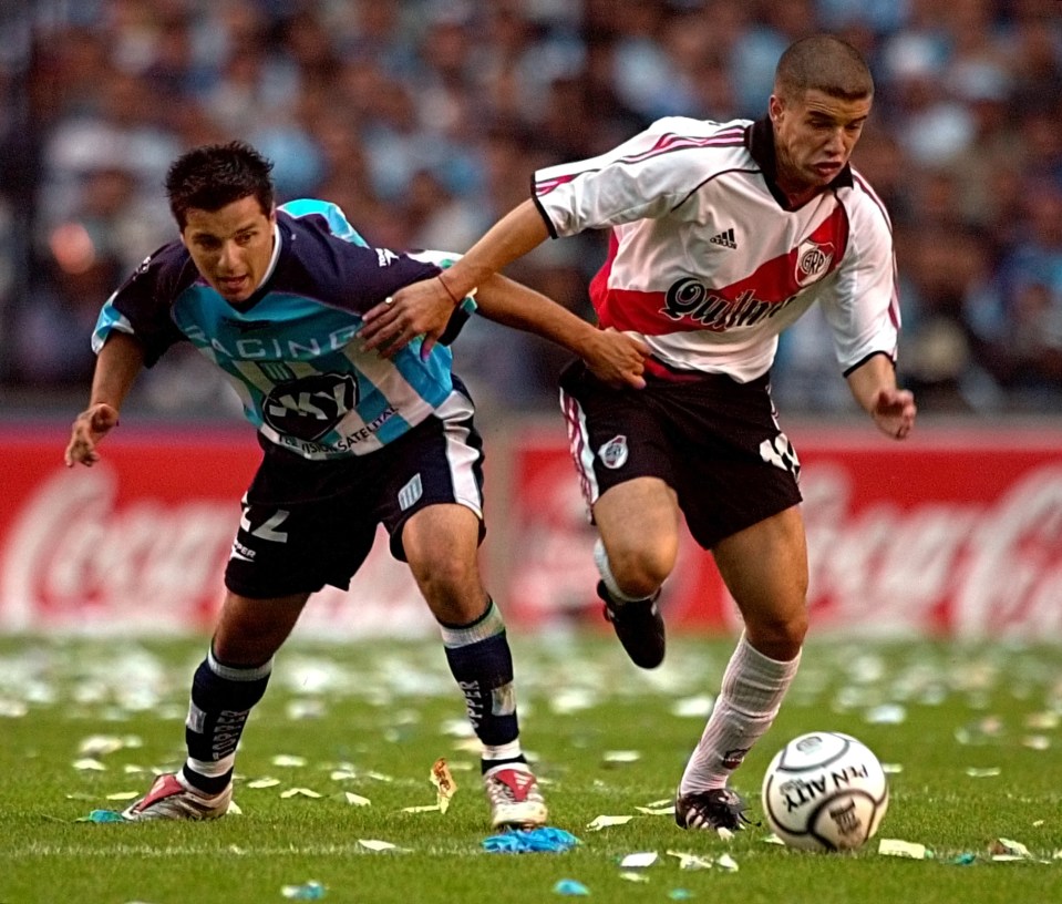 Andres d'Alessandro, right, of River Plate battles for the ball with Maximiliano Estevez, left, of Racing Club, Sunday, Dec. 2, 2001, during their Argentine first division soccer game in Buenos Aires. The match ended in a 1-1 tie. (AP Photo / Daniel Luna)