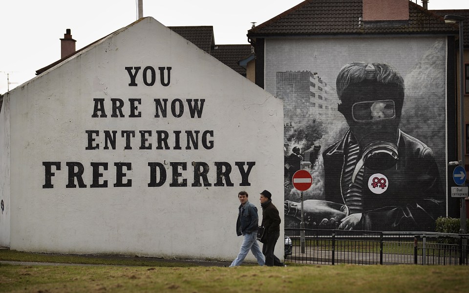  Two residents walk past Free Derry Corner in the Catholic Bogside area of Derry on March 15, 2010, in Northern Ireland