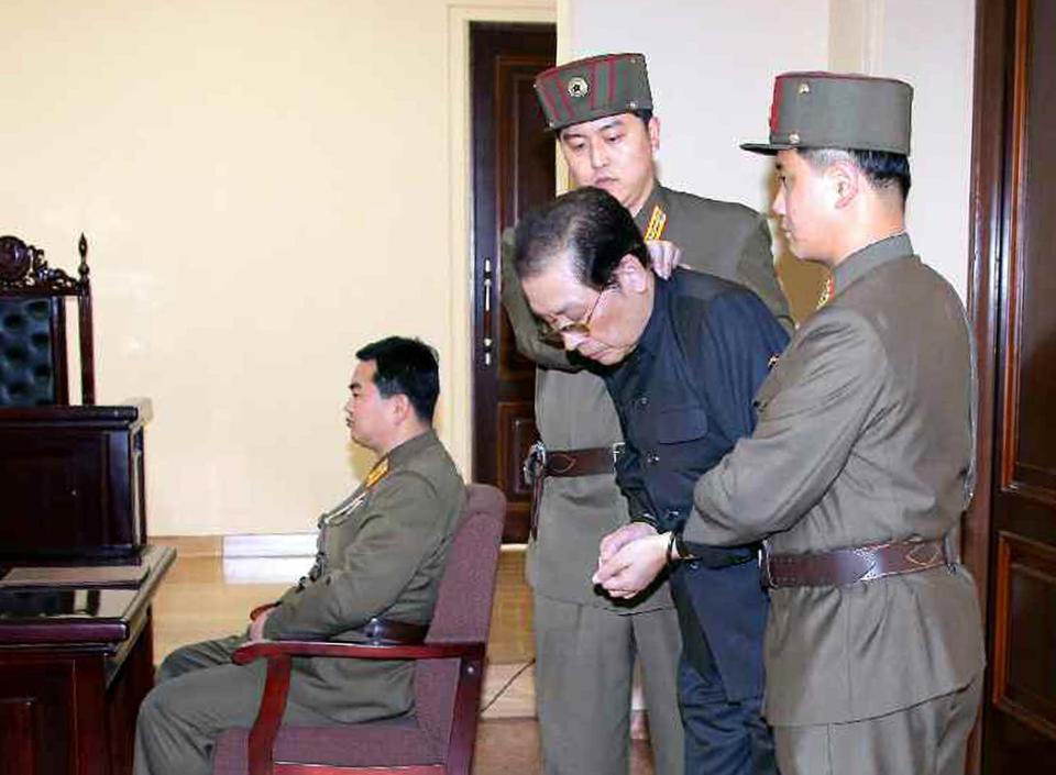  Kim's uncle Jang Song-Thaek being escorted from court before being executed