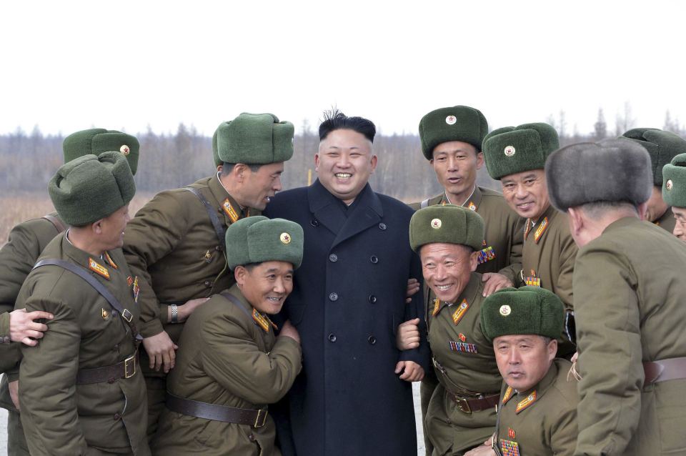  Kim smiles as he stands with commanding officers of the combined units of the Korean People's Army (KPA)