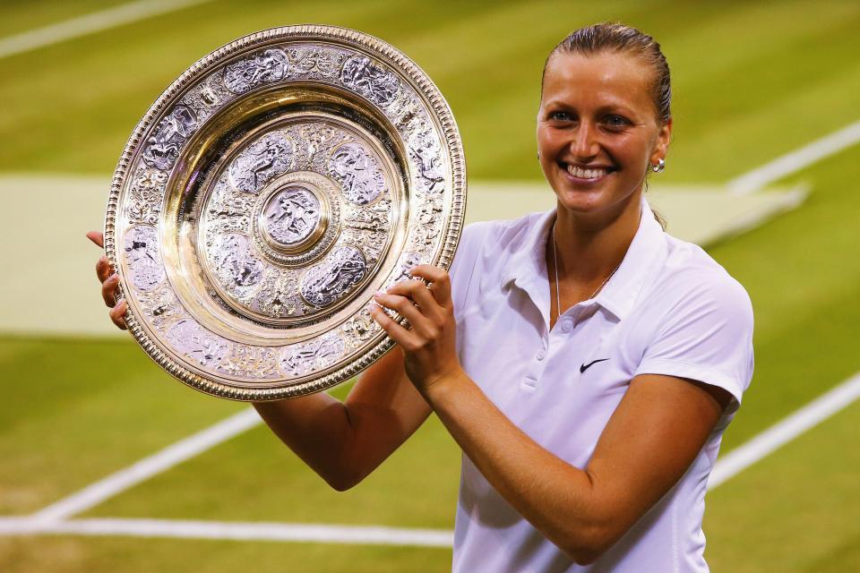  Petra Kvitova of Czech Republic poses with the Venus Rosewater Dish trophy after her victory in 2014