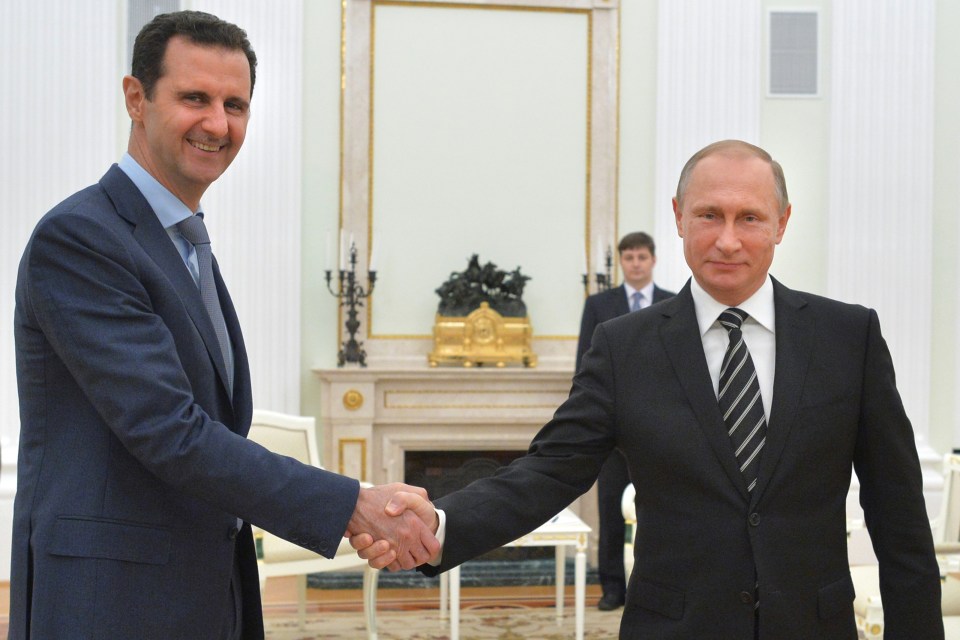  Russian President Vladimir Putin, right, shakes hand with Syria President Bashar Assad in the Kremlin in Moscow, Russia