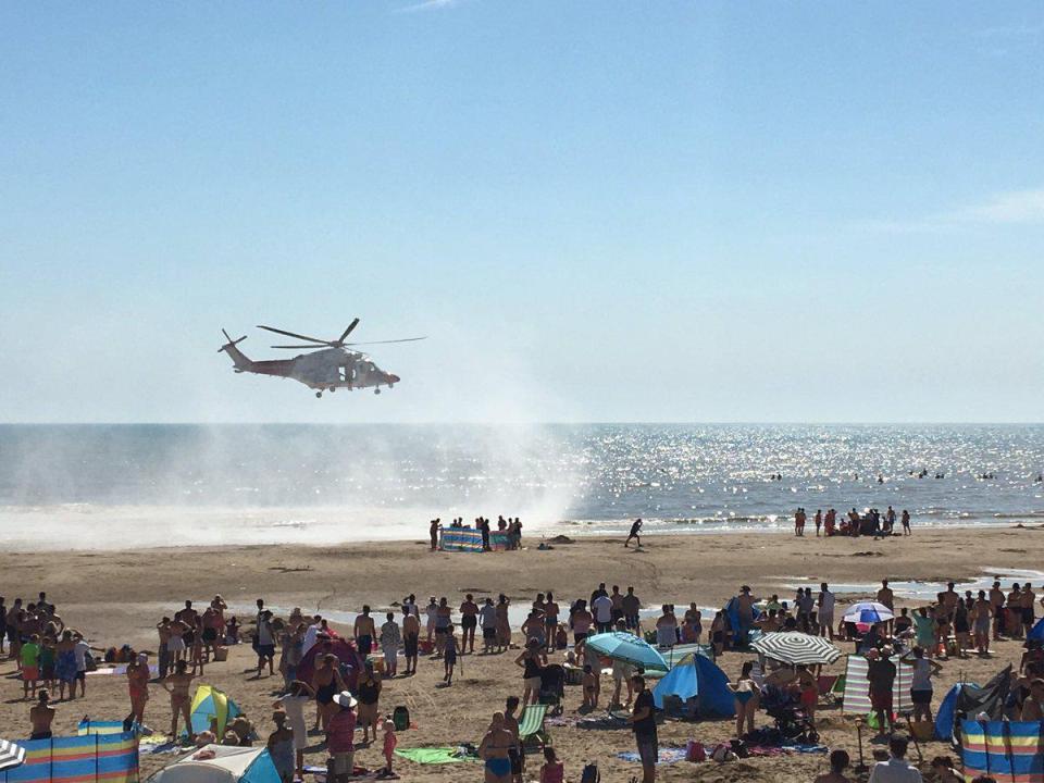  An emergency helicopter arrives at Camber Sands - the day five friends drowned at the beach