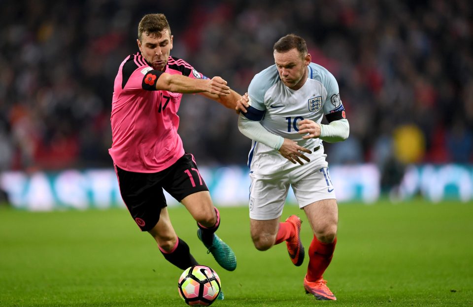  Wayne Rooney of England tussles with James McArthur of Scotland