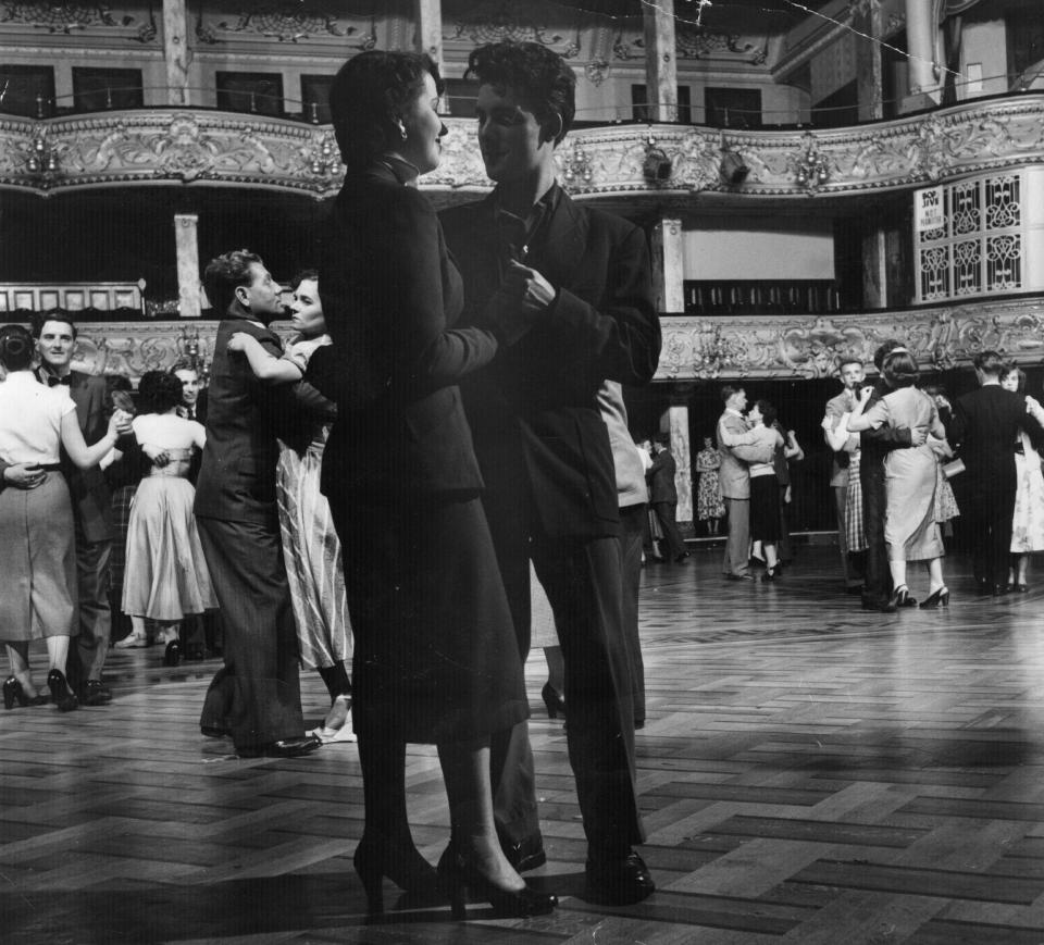  A loved-up couple share a tender moment in 1953 while sashaying around the room at a grand ball