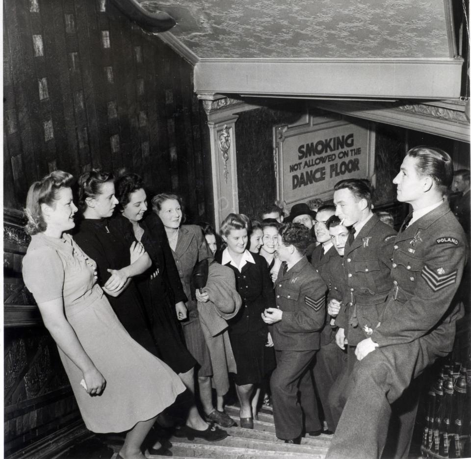  Smartly-dressed Polish soldiers coyly chat up local Blackpool girls, who are dressed in pretty midi dresses, during a dance event in the 50s