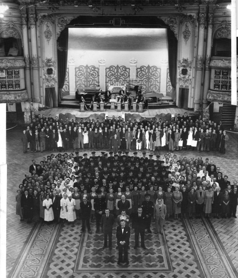  Dozens of Blackpool Tower Ballroom staff don their gladrags and pose for a group shot together in 1953