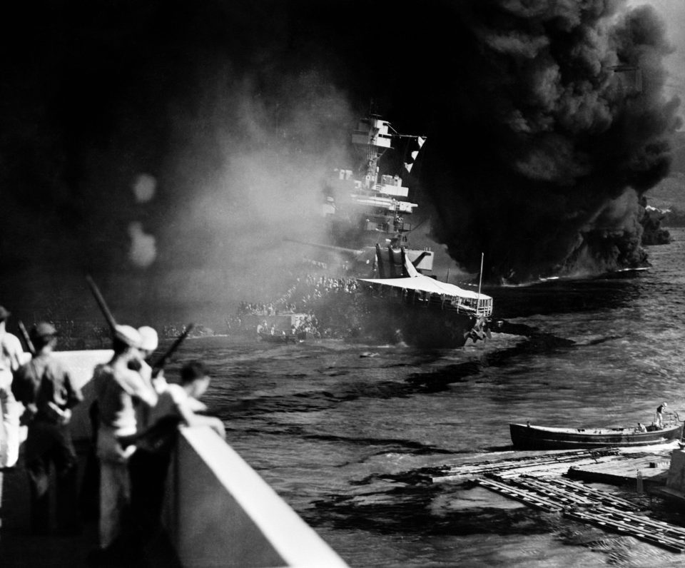 Battered by aerial bombs and torpedoes, the USS California is evacuated