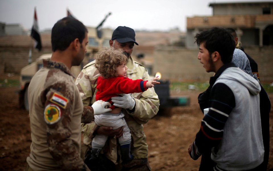  A child cries after being rescued from ISIS territory ... Families are being used as human shields by terrorists