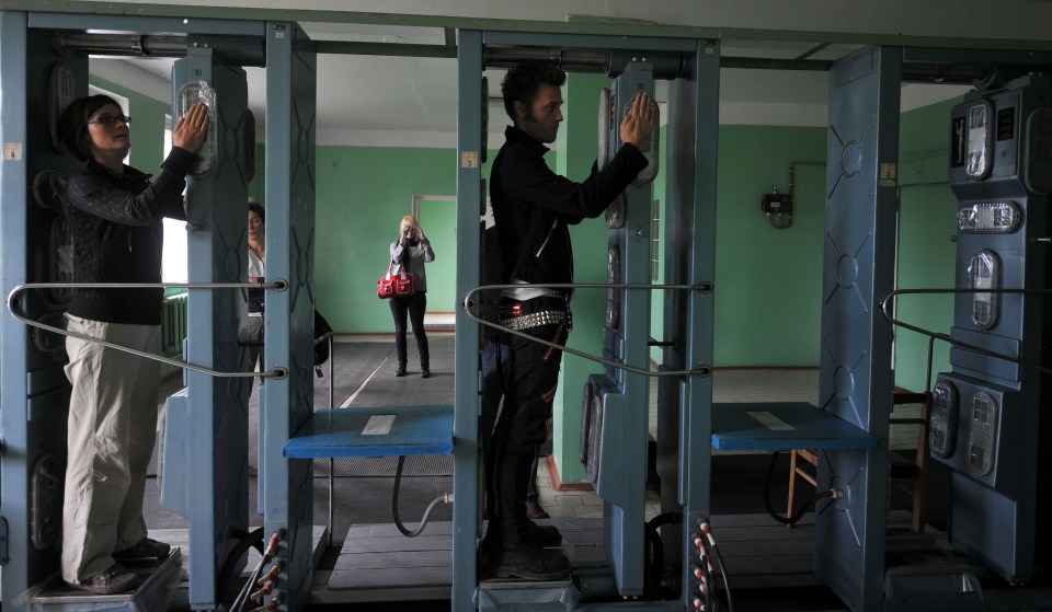 Tourists pass a radiation control point as they leave the Chernobyl 30-km exclusion zone