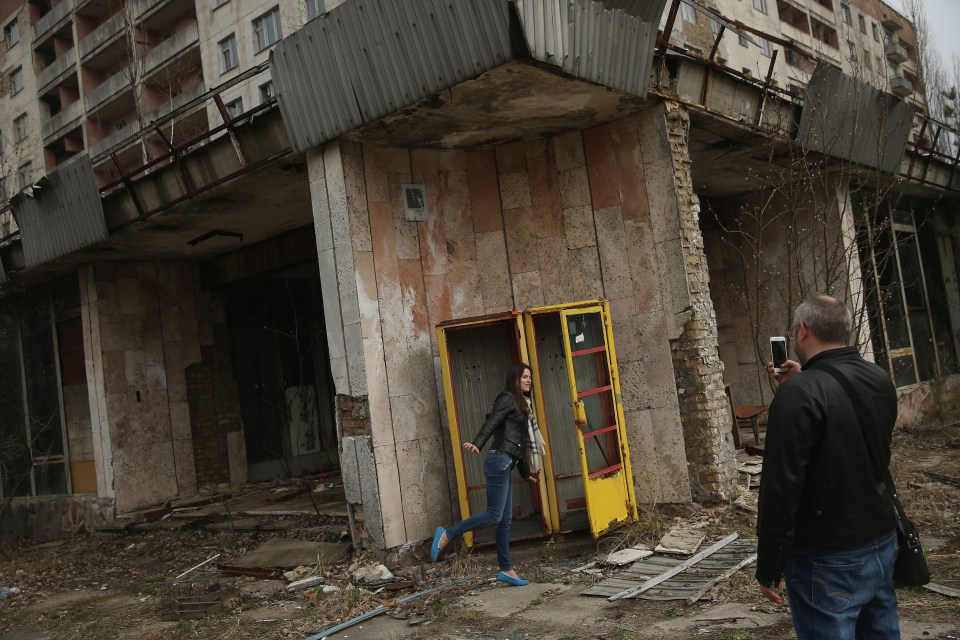 Tourists outside an abandoned shop in Pripyat