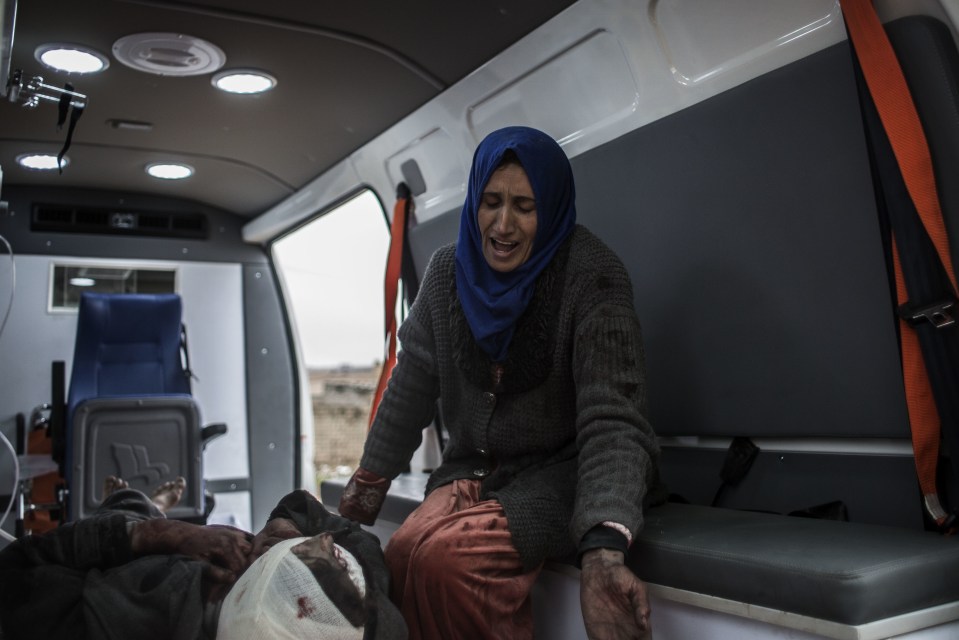  A woman weeps over her injured son ... Nearly 1,000 civilians were killed in the battle for Mosul last month