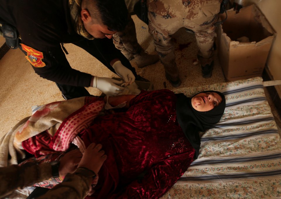  An Iraqi woman is treated for injuries ... ISIS snipers are shooting at fleeing civilians