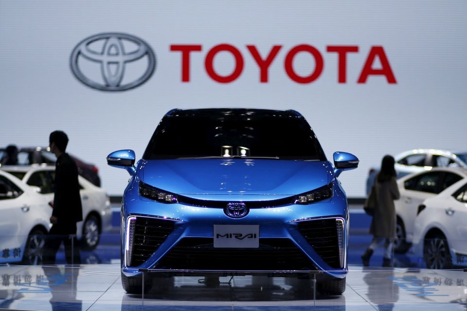 a blue toyota mirai is on display at a car show