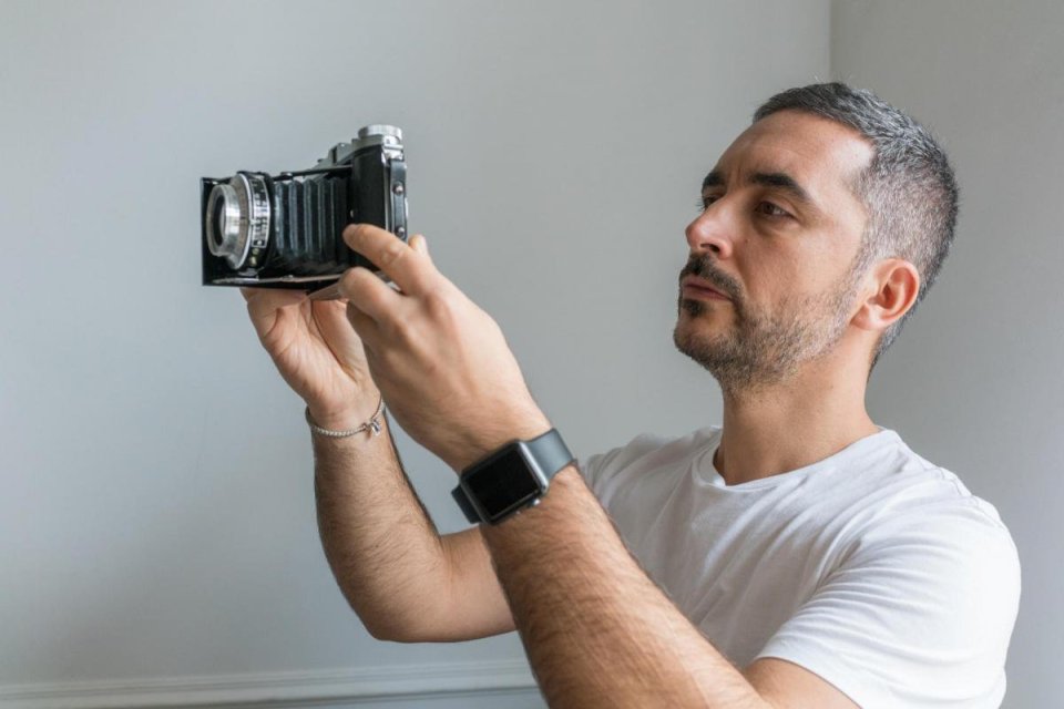 Alex, who works as a fashion photographer, poses with the camera he purchased online