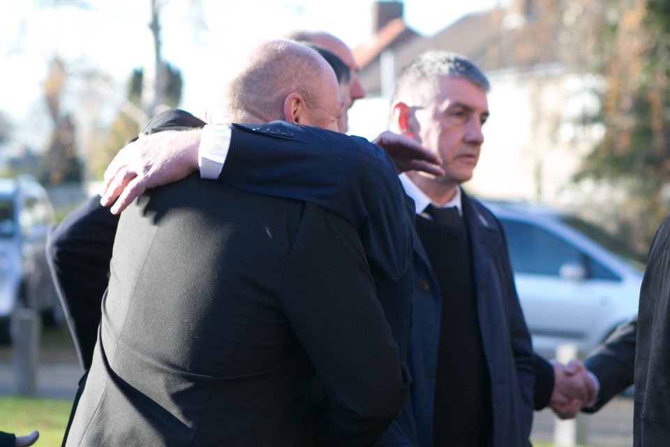  Mourners comfort each other outside the funeral of Croydon tram crash victim Philip Seary