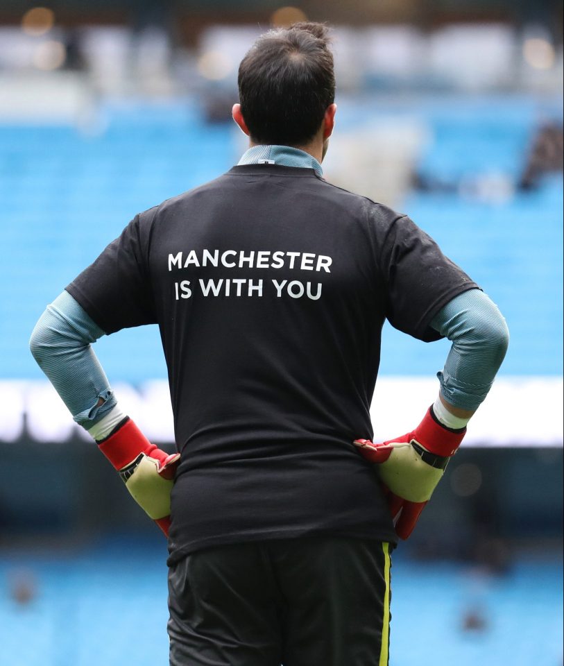  Man City's t-shirts read 'Manchester is with you' across the back