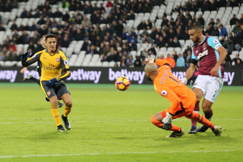 Alexis Sanchez of Arsenal scores his hatrick with a special chip over West Ham's Randolph 