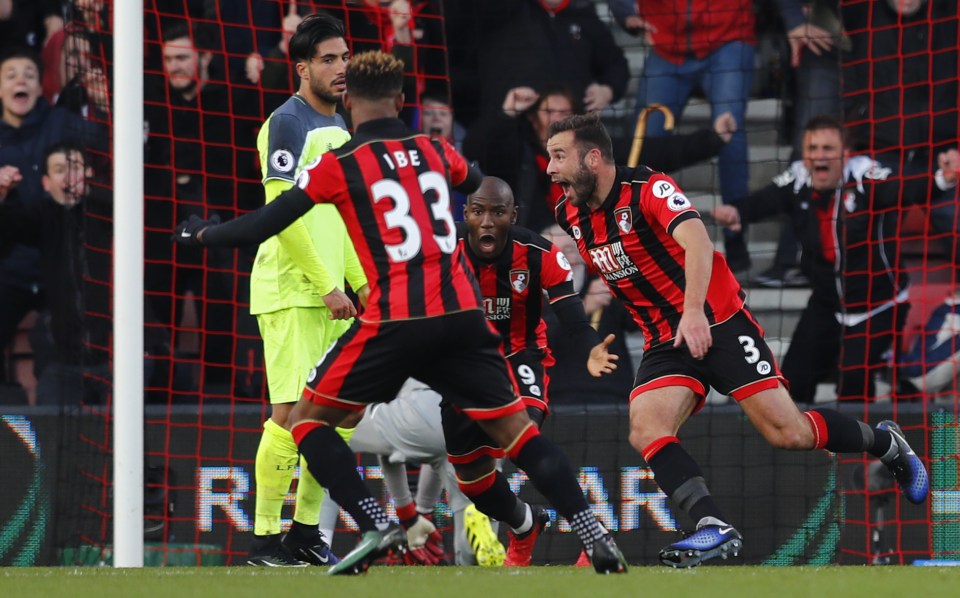 Steve Cook wheels away (right) after showing a striker's instinct to bring Bournemouth back into it at 4-3