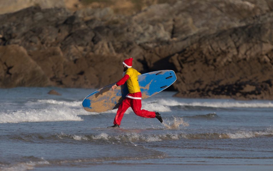 Another surfing Santa can't wait to get into the freezing cold sea 