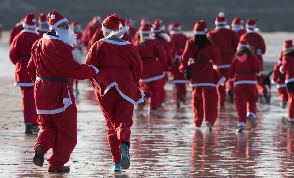 The Santas descended on Newquay's Fistral Beach for the annual Santa Run and Surf 