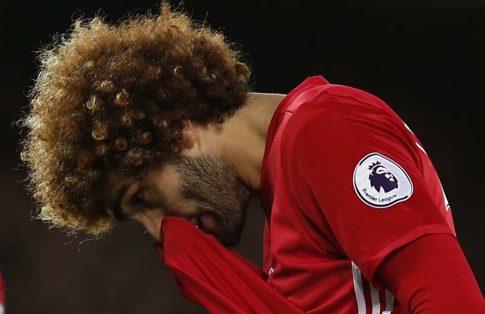 Fellaini hangs his head as he realises what he has done only minutes after entering the field