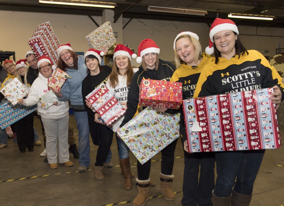 Several helpers came together to wrap presents for young children who have suffered the loss of a parent serving in the armed forces today