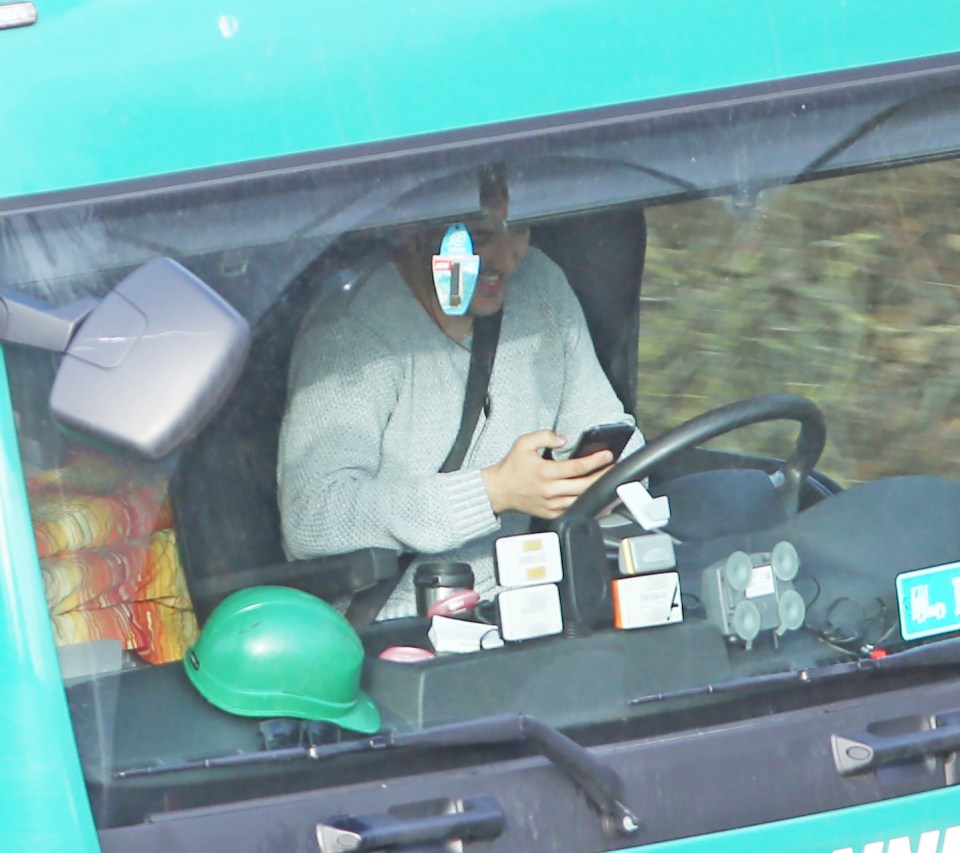  This driver can be seen chuckling while looking at his phone on the M20