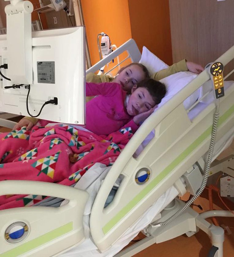 Jessica is comforted by her sister Olivia while in hospital in November 2015 