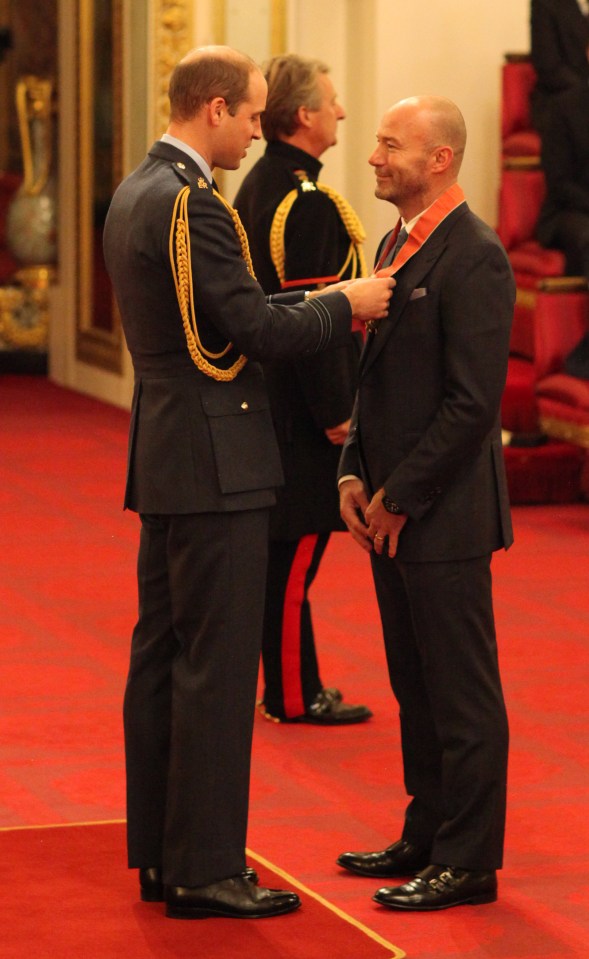 How's your barber . . . Alan Shearer receives CBE from a balding Prince William