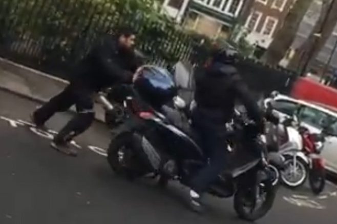  One have-a-go-hero tries to shove one thief off his moped