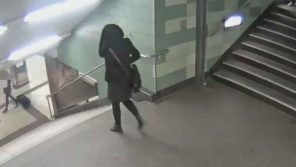  CCTV shows a woman walking through a metro station in Berlin