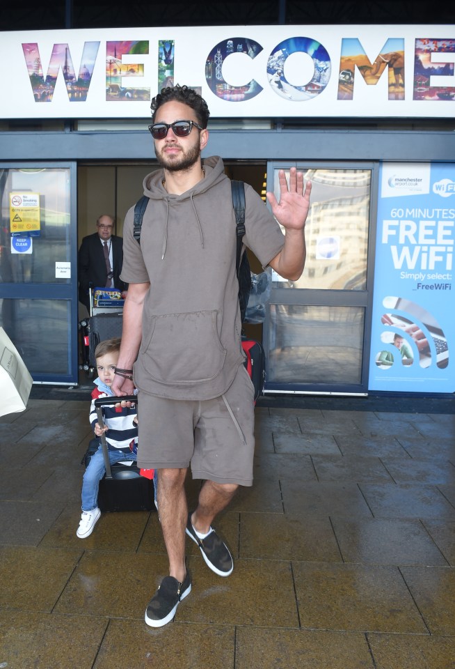 He barely managed a smile as he left the Arrivals Lounge at Manchester Airport