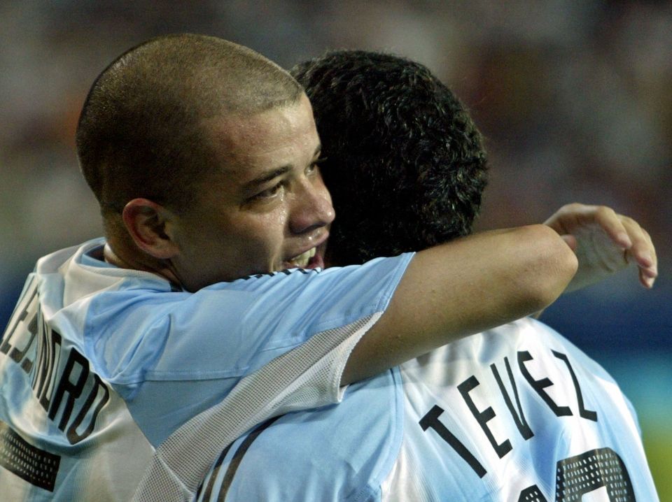 Argentina's striker Andres D'alessandro (L) embraces team mate Carlos Tevez after soring his team's first goal during the first half of their Group C soccer match against Australia at the Athens 2004 Olympic Games, August 17, 2004. Argentina defeated Australia 1-0. REUTERS/Marcos Brindicci MBR/DL - RTRVGK1