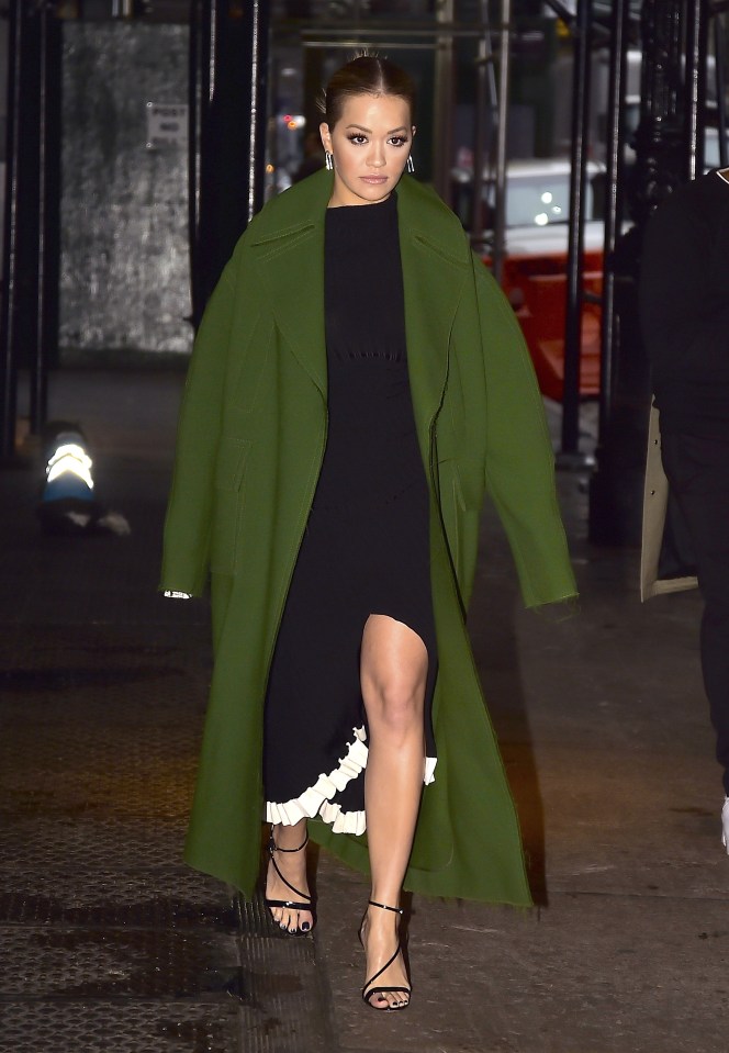  She flashed some leg as she left the Today show in a black and white midi dress under an olive green coat