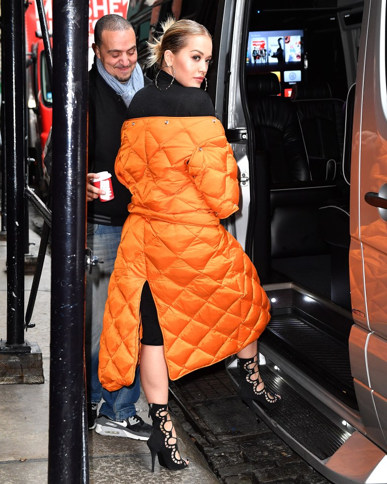  She wore her bright orange coat over a black dress and black lace-up stilettos