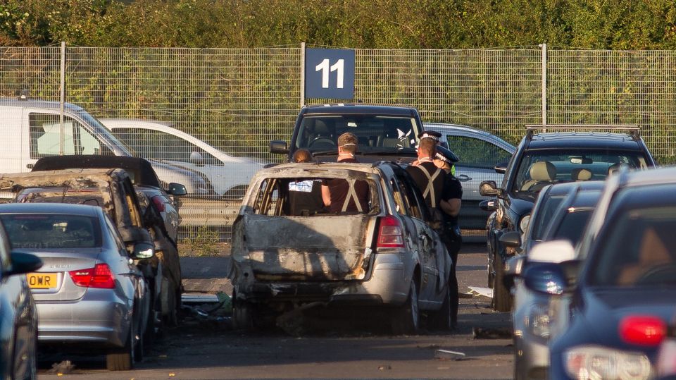  Emergency workers at the site of the crash, after the plane landed in a car park