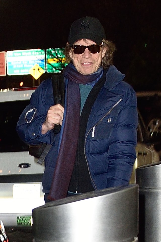 A grinning Mick Jagger arrived at JFK airport in time for the birth