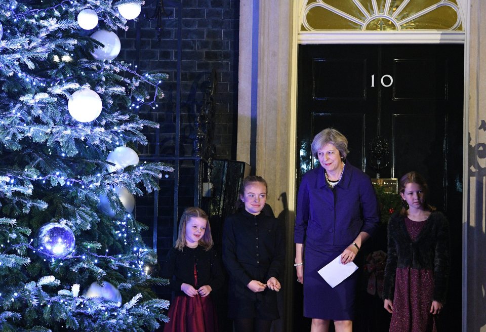  Prime Minister Theresa May sings carols by a Christmas tree set up outside No. 10 Downing Street