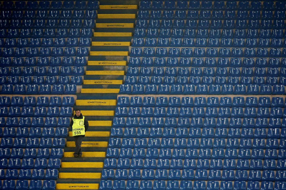  A steward stands in the tribune during the match