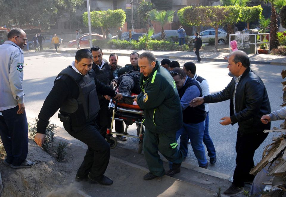  Rescue workers carry a wounded victim at the site of the deadly bomb attack in Egypt