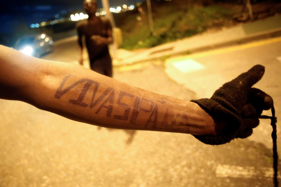  An African migrant shows the words "Viva Spain" on his arm after crossing