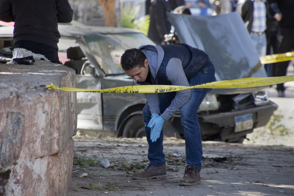  An explosives expert looks for evidence at the site of the bomb explosion