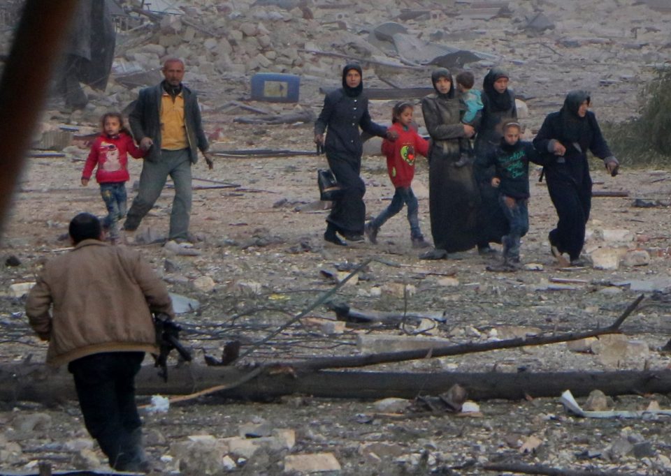  Bombed out people escape from the scene of the air strikes