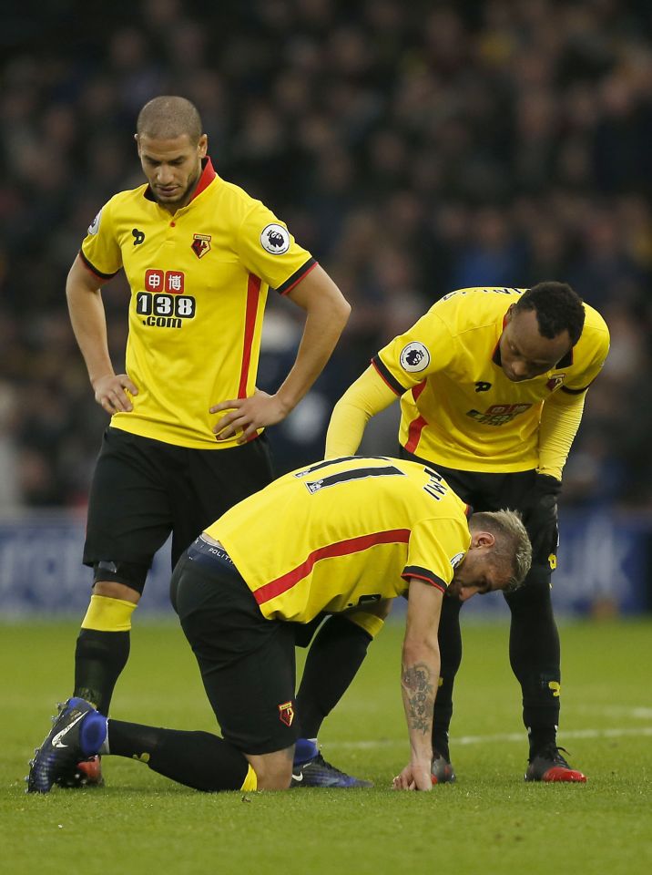 Watford players comfort a sick looking Valon Behrami