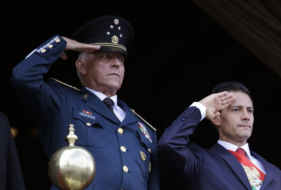  Defence Secretary General Salvador Cienfuegos, left, and Mexico's President Enrique Pena Nieto, salute during the annual Independence Day military parade