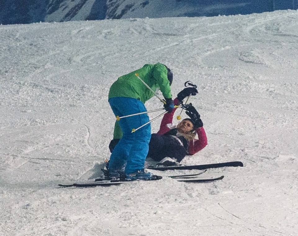  Tangled up in her skis, Josie was helped by her instructor