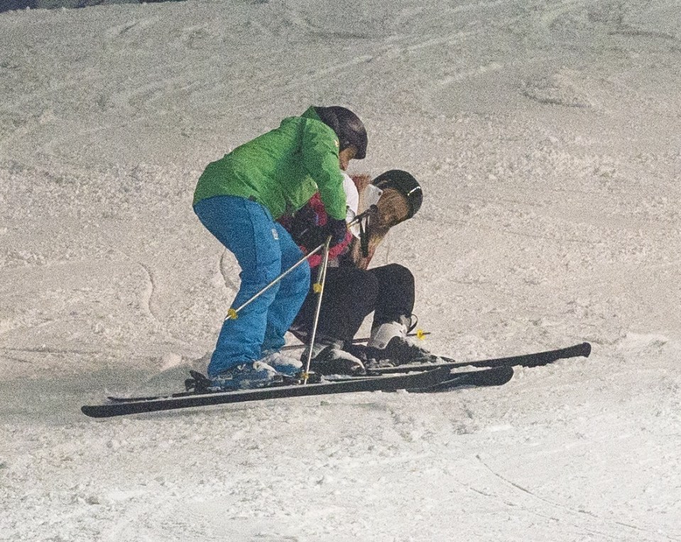  Dragging herself up, she got back on her skis and set off again