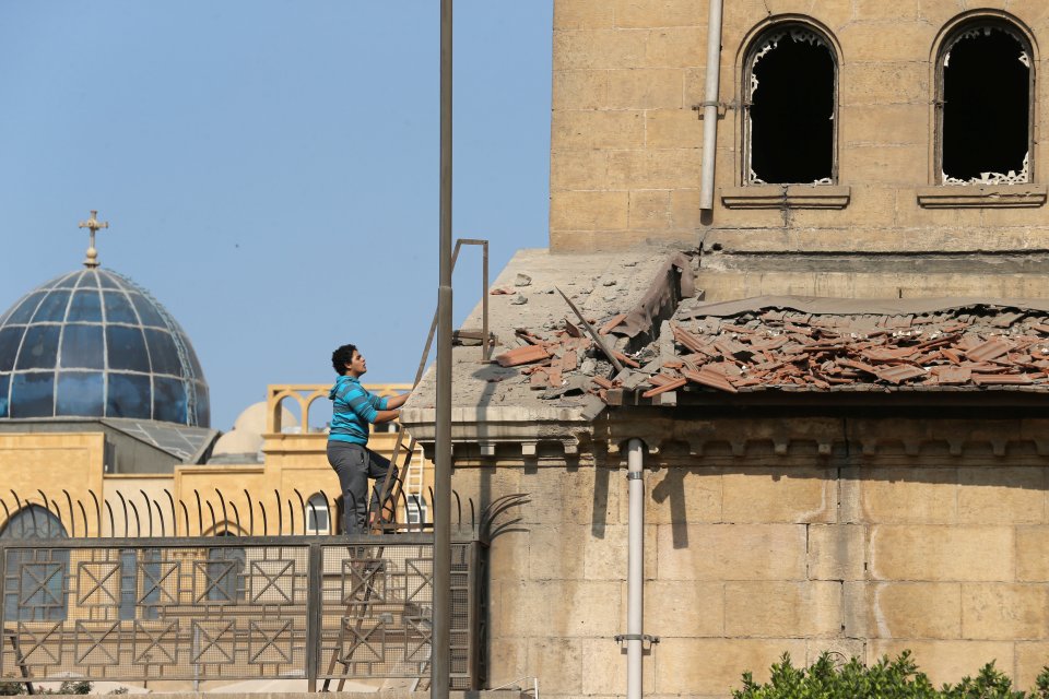 A worker surveys the damage at the site